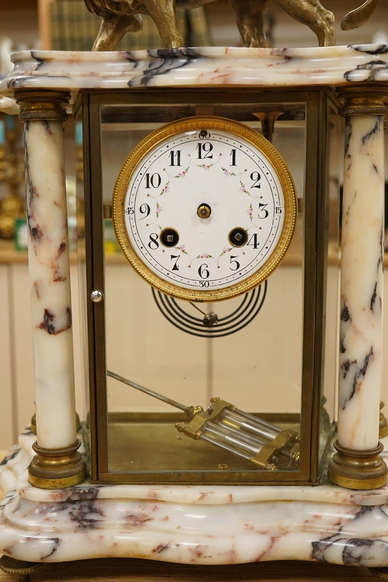 An early 20th century marble mantel clock with lion surmount, with pendulum, 39cm high